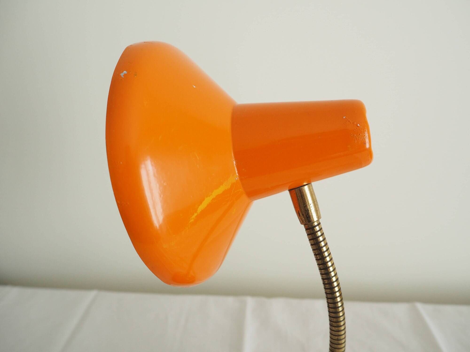Orange colored metal desk lamp from the 1960s-1970s