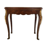 Console transforming into a 19th century Louis XV style gaming table
