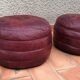 Pair of vintage poufs in burgundy leather patchwork, 1970