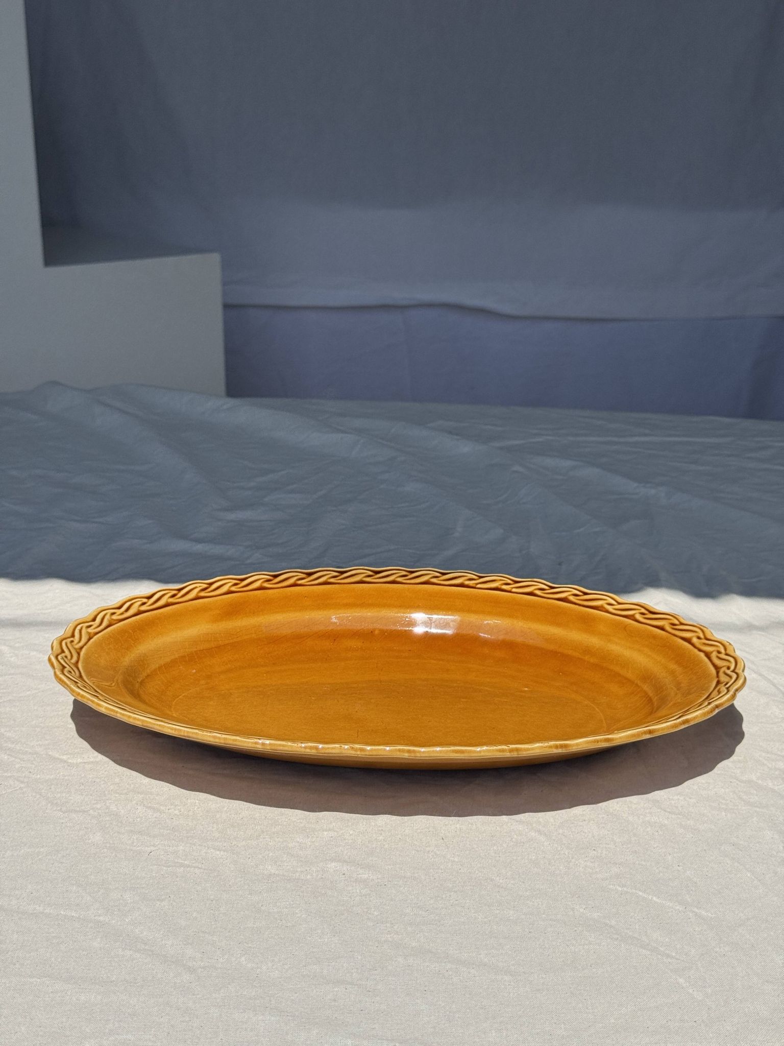 Antique oval dish, yellow-orange, frieze border L:24
