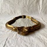 Old small wall mirror in golden resin