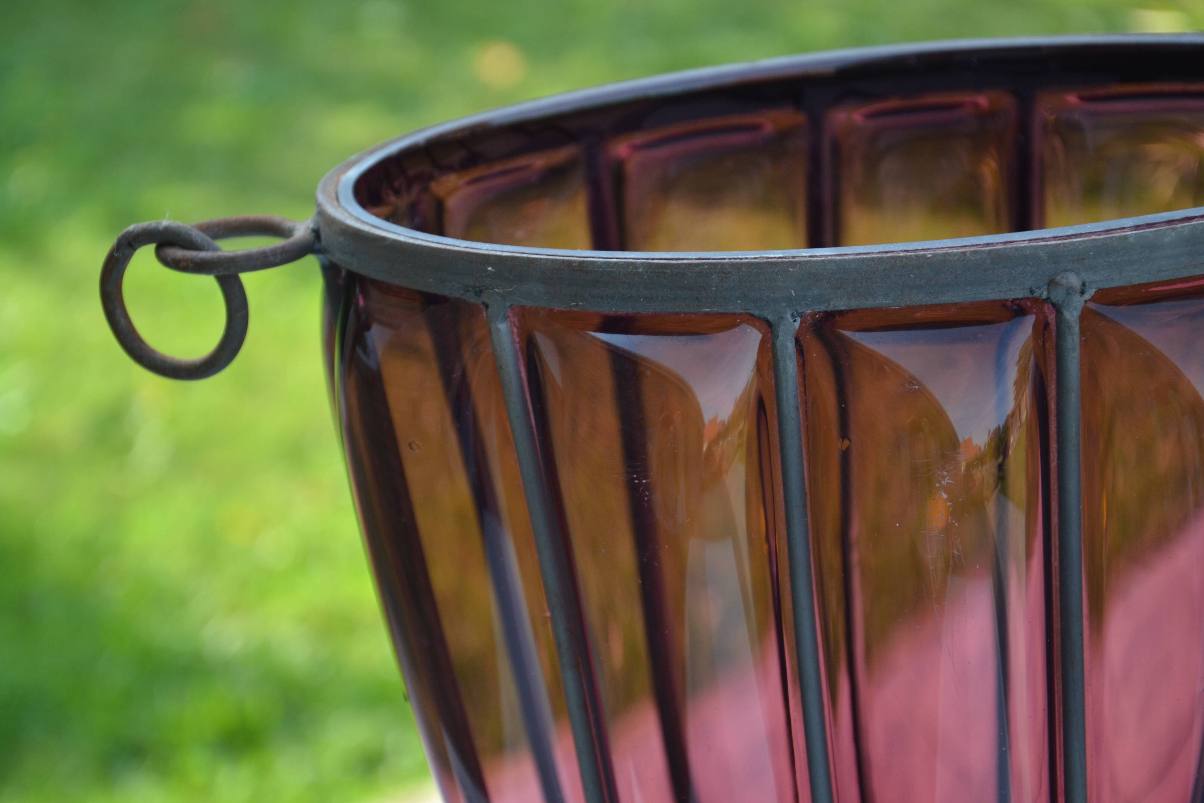Large blown glass and wrought iron vase on shower stand