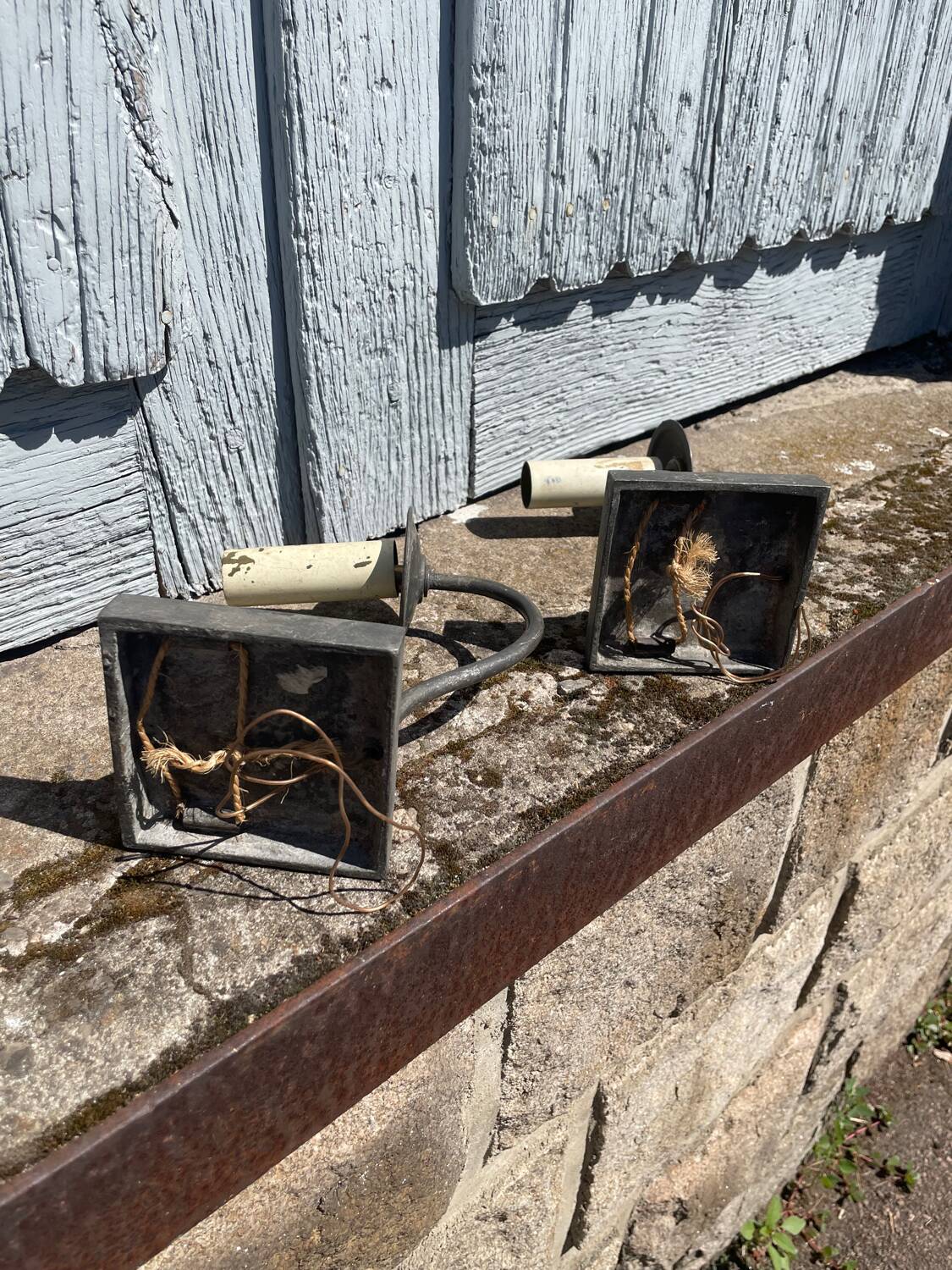 Two lion head wall sconces in tin.