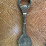 Bottle opener, opens bottle in golden brass shape of racket design and vintage