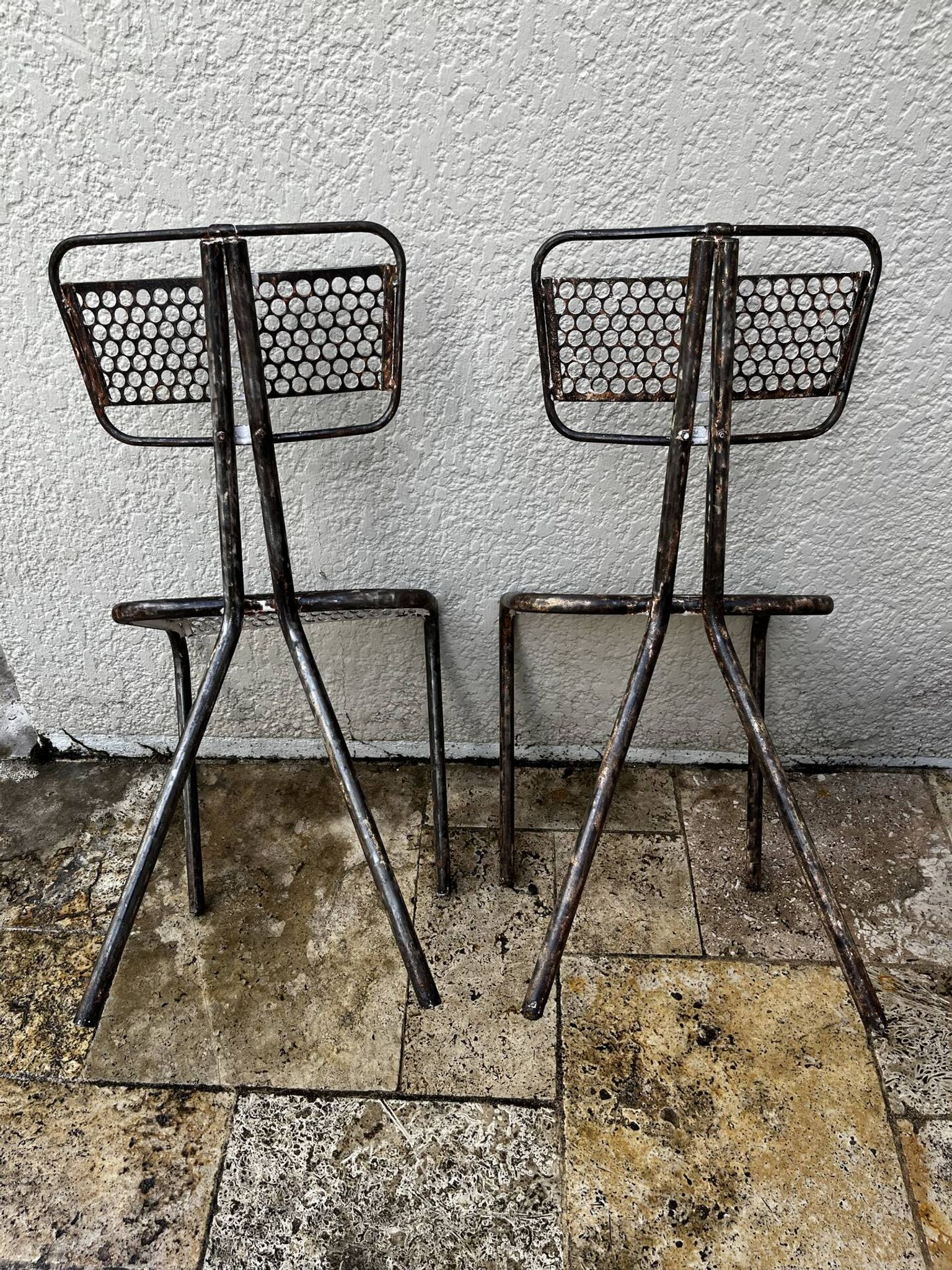 Pairs of perforated metal chairs by René Malaval