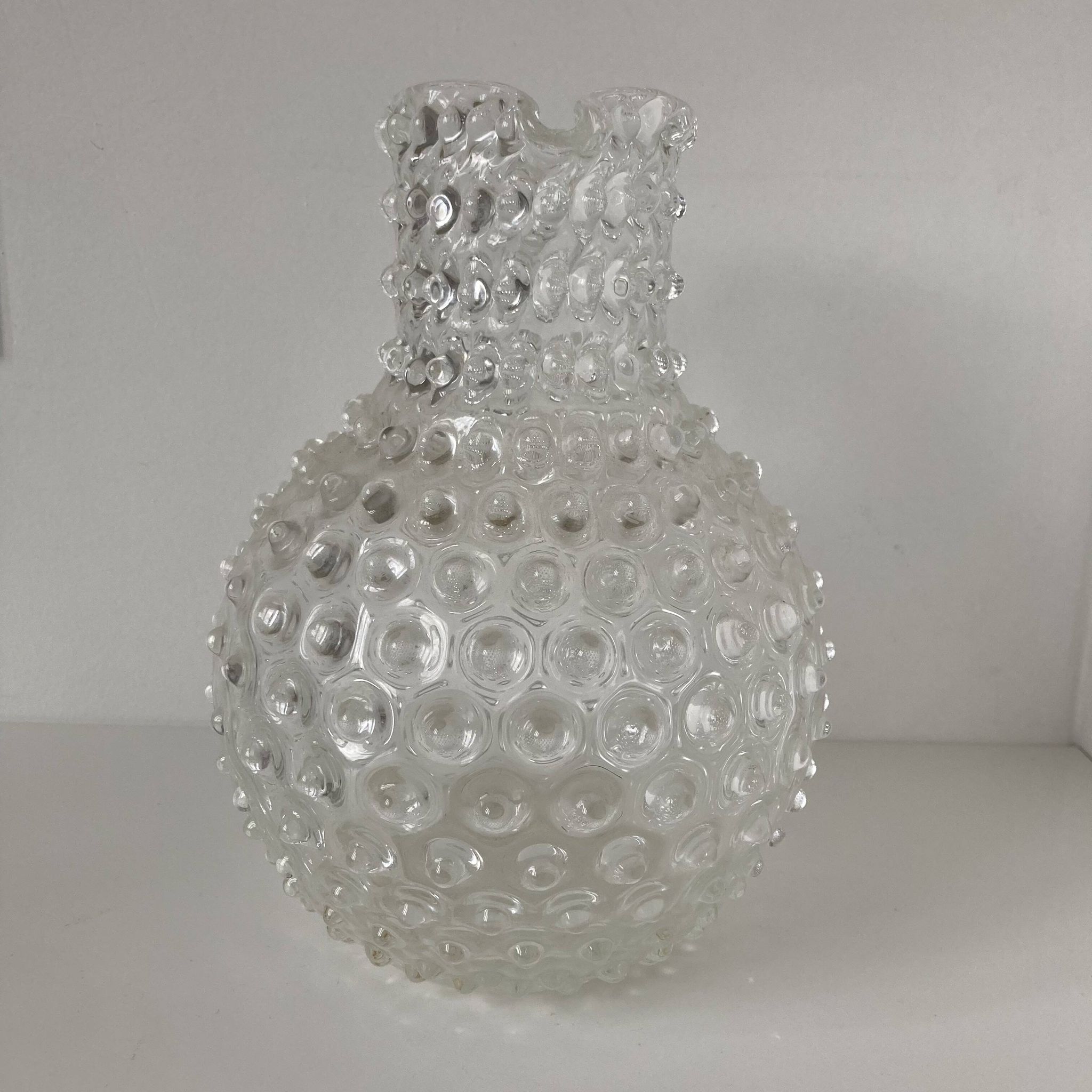 Beautiful and large vintage glass jug with a handle, made of clear hot-worked glass.