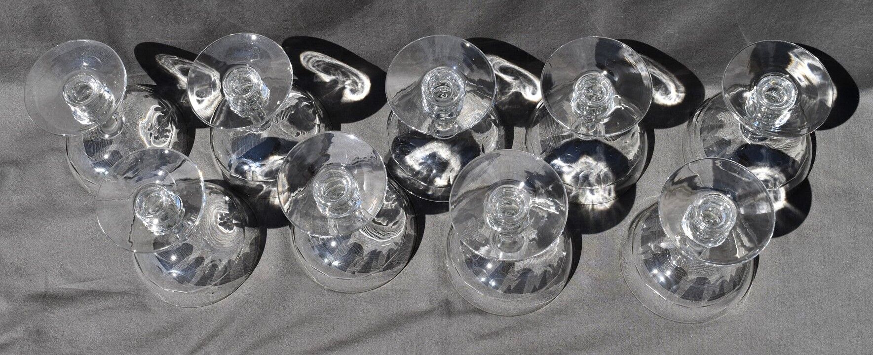 9 old champagne glasses in flat-waisted blown glass