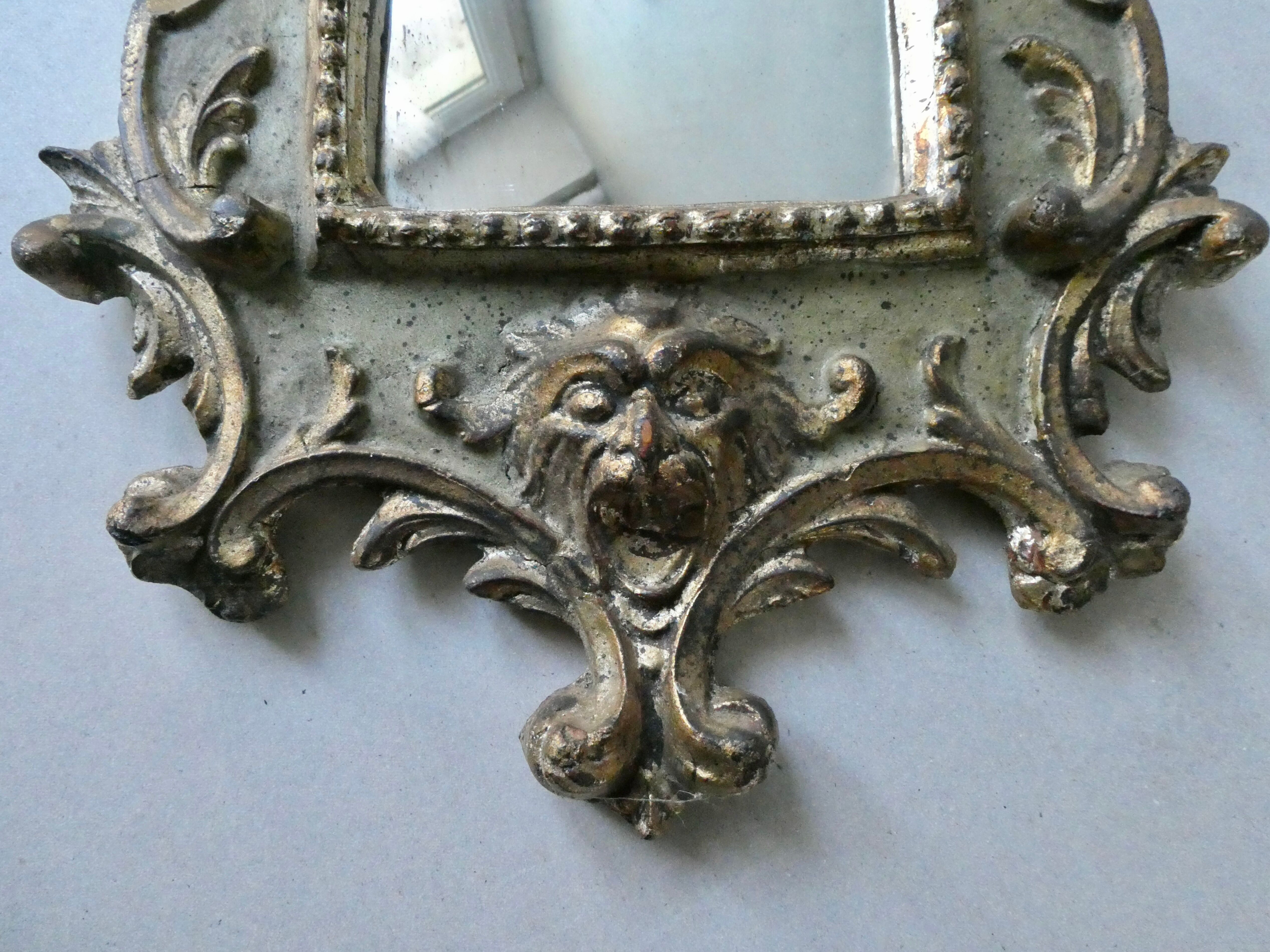 Mirror with cherub head in gilded wood, Venetian baroque style