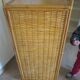 Storage column, wooden bookshelf and woven rattan.