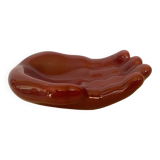 Empty pocket in the shape of a burgundy hand