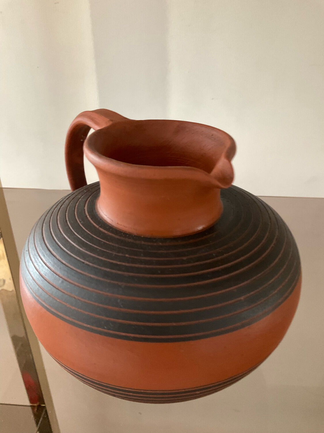 Vintage jug in chiseled terracotta