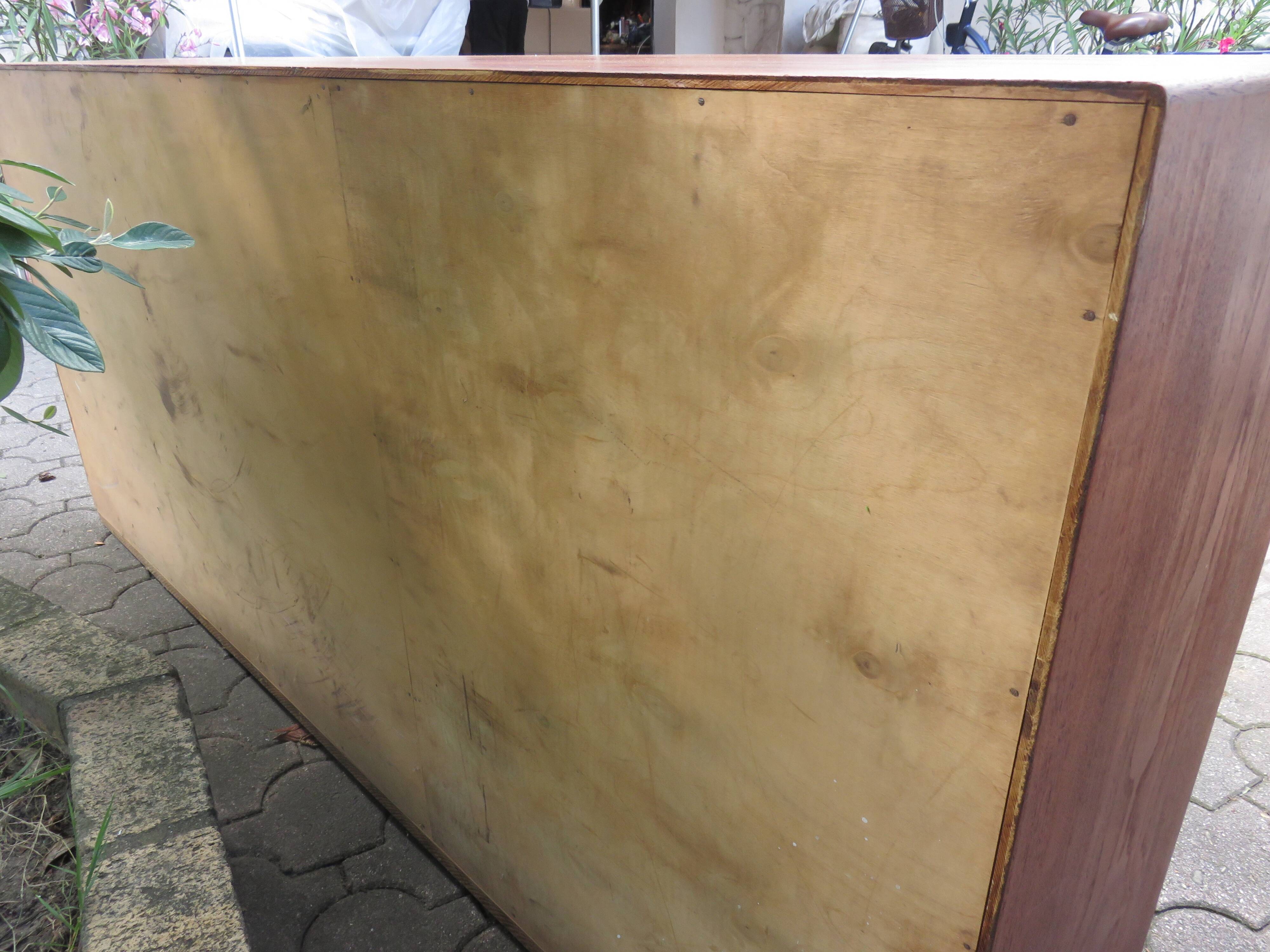 Low sideboard with 3 sliding doors in teak. Denmark 1960