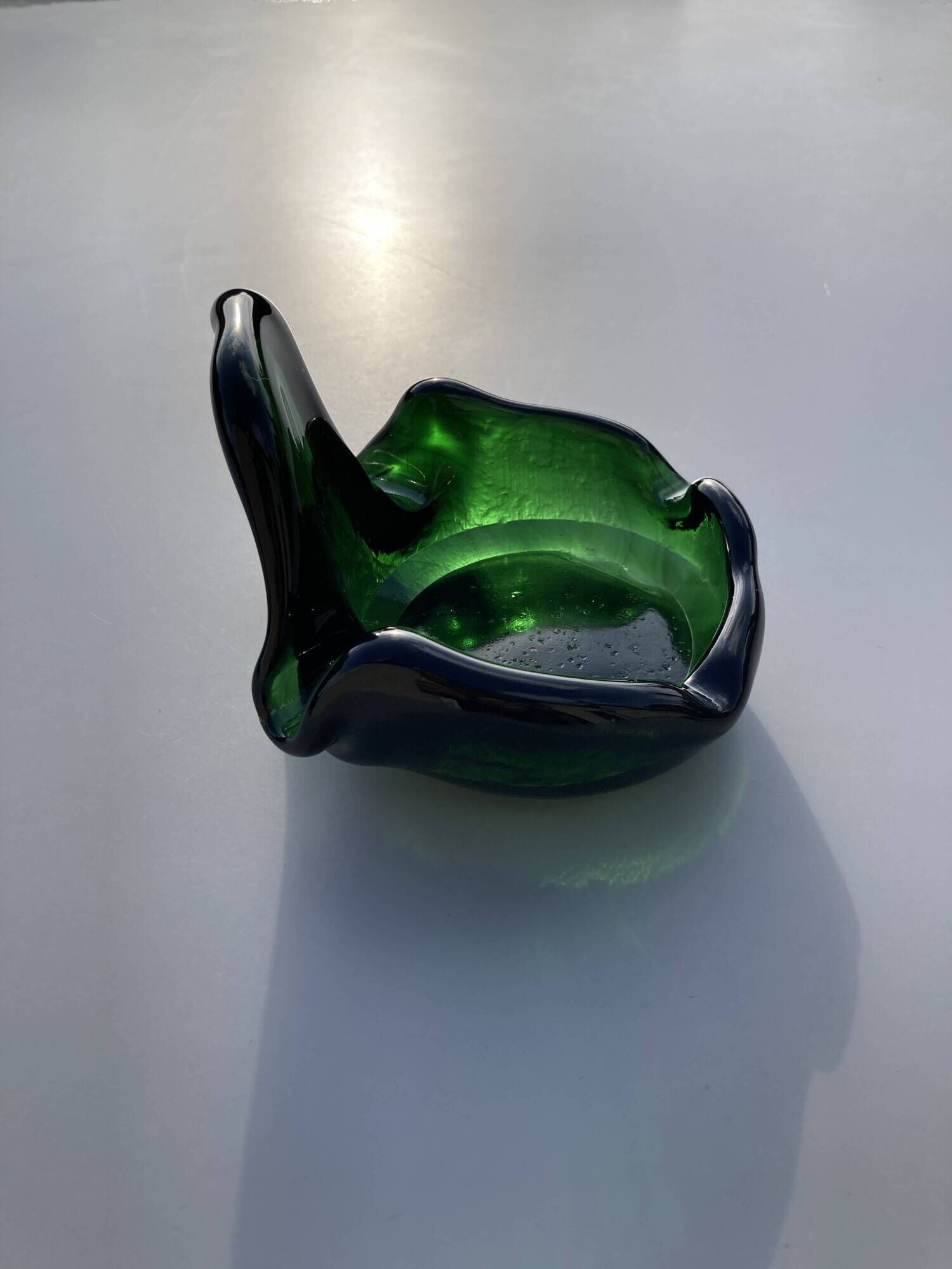 Sculptural ashtray in emerald green glass