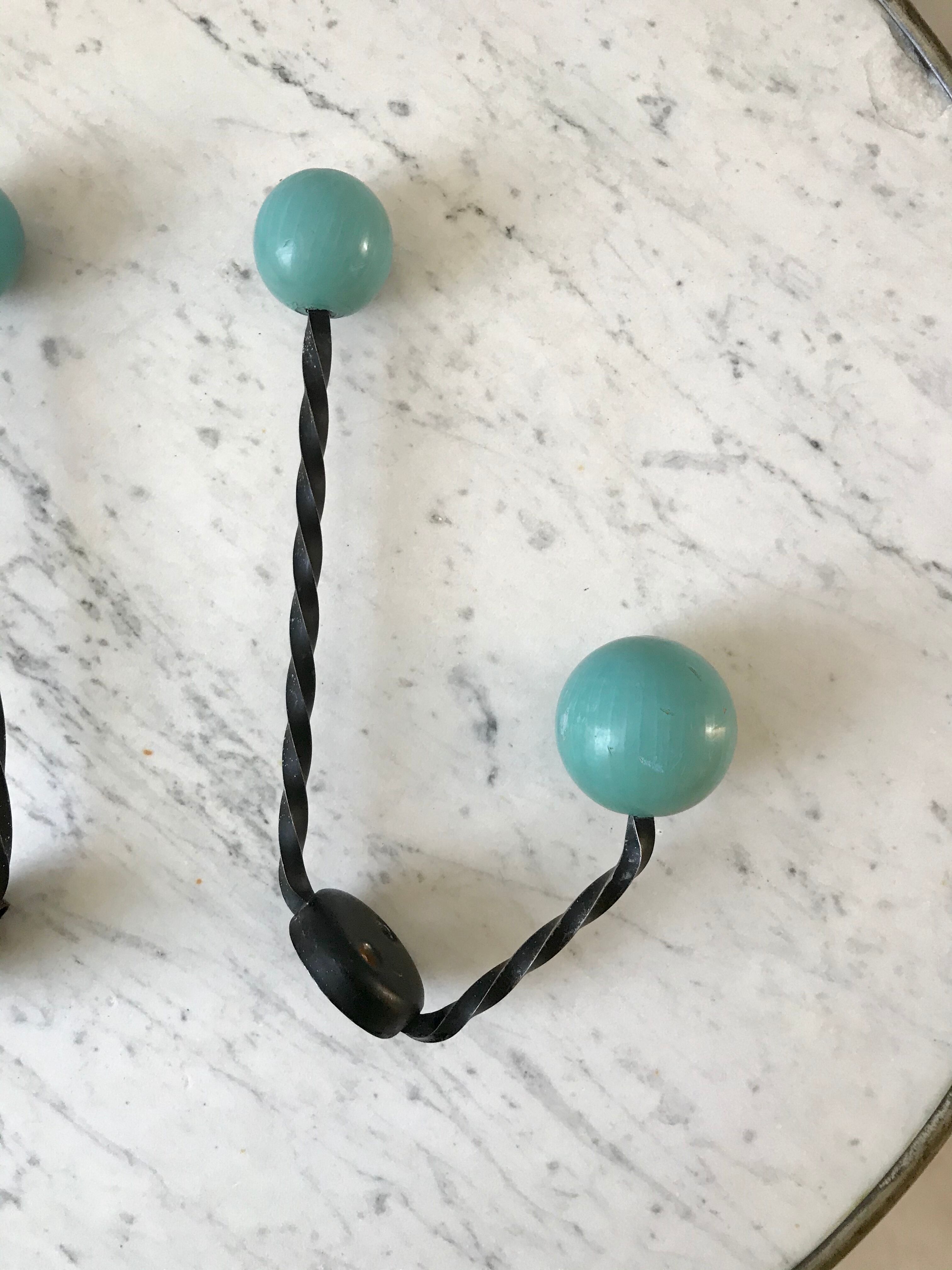Duo of hooks balls in blue wood and black iron 60s