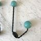 Duo of hooks balls in blue wood and black iron 60s