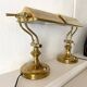 Pair of notary-style lamps in gilded metal