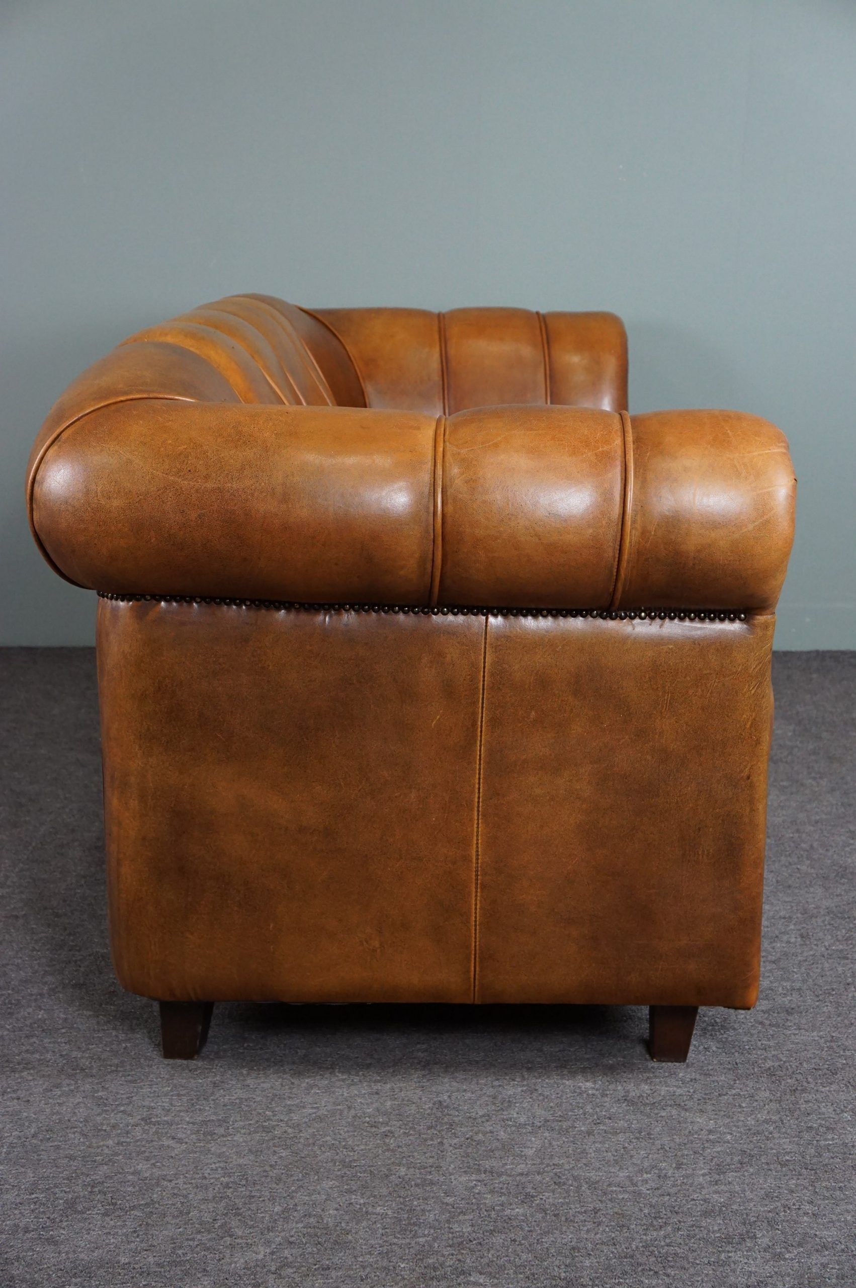 Sheepskin sofa with decorative nails