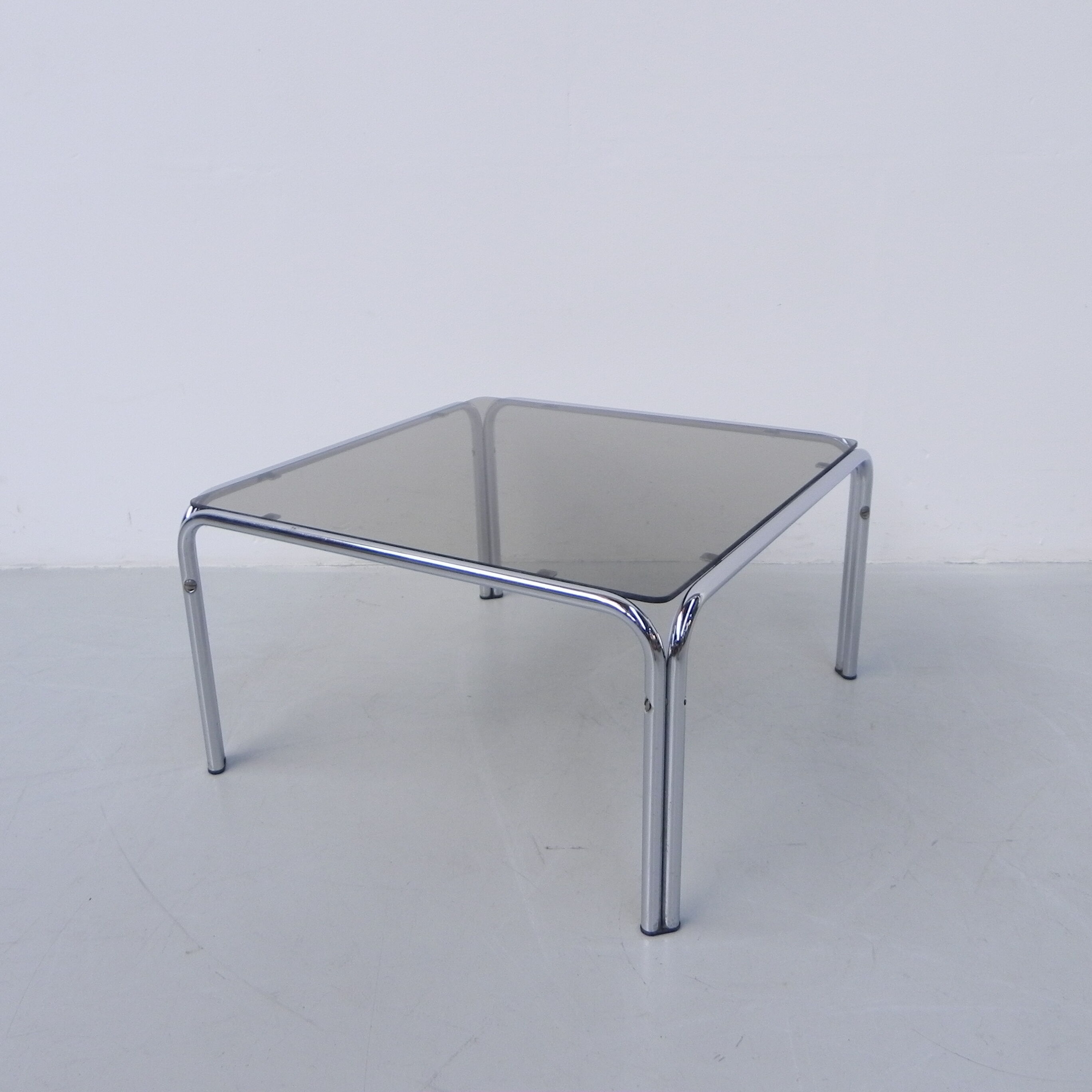 Coffee table with smoked glass top in chromed frame