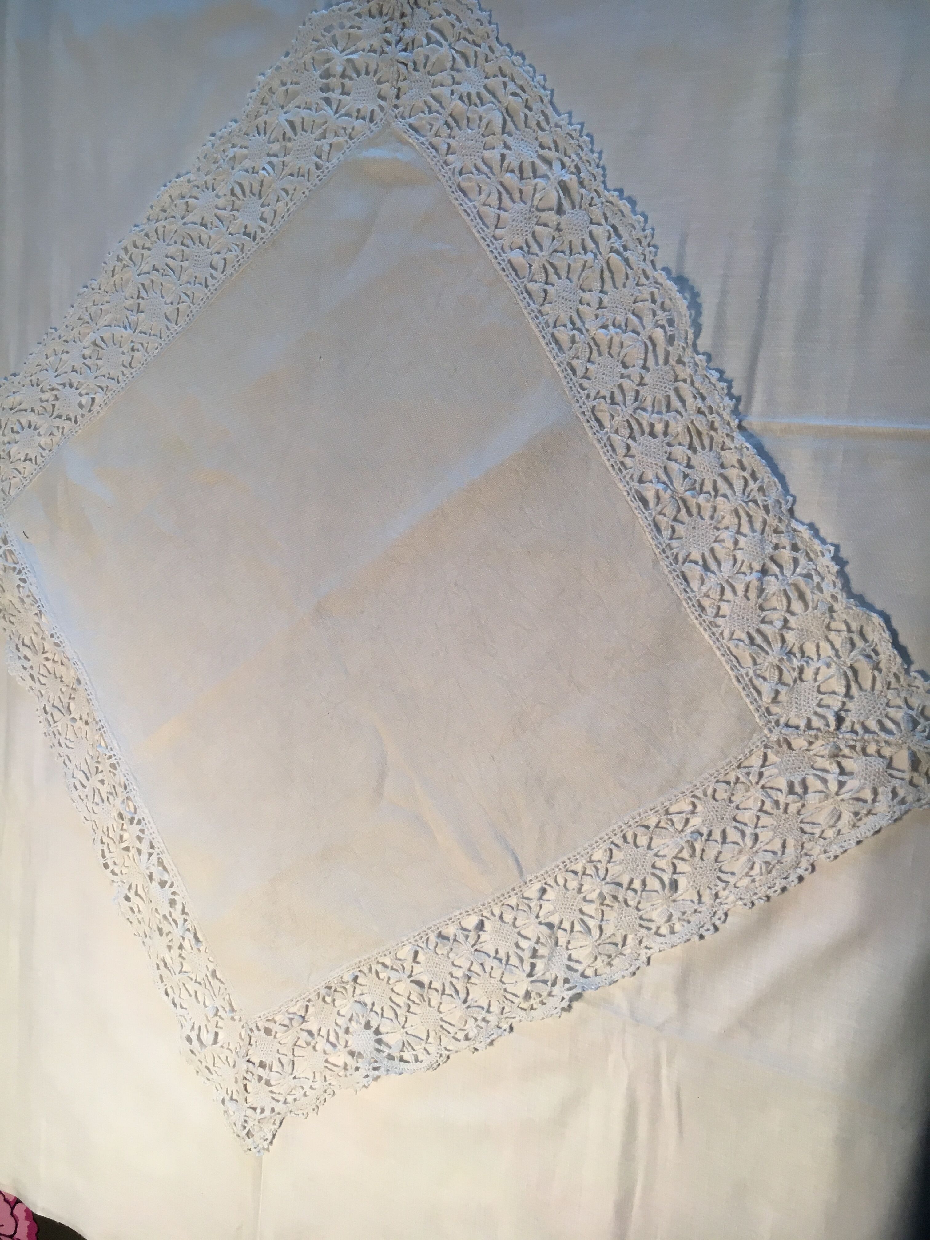 Old embroidered white linen and surnappe tablecloth
