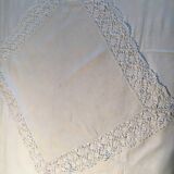 Old embroidered white linen and surnappe tablecloth
