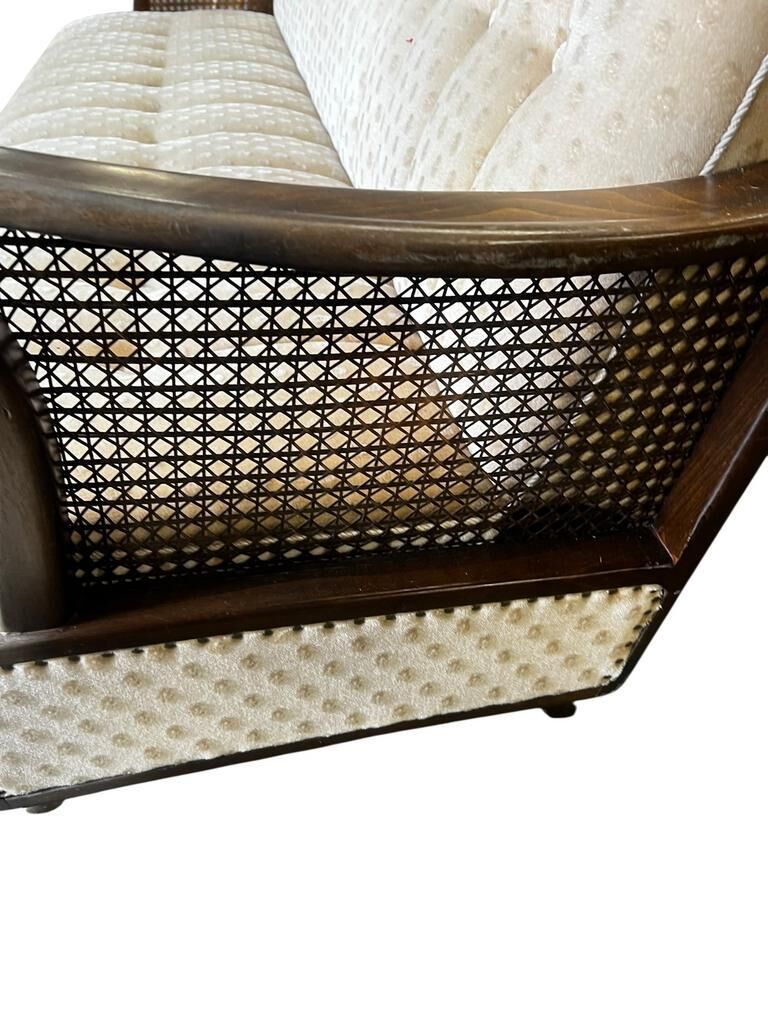 Vintage wooden armchair with rattan weaving.