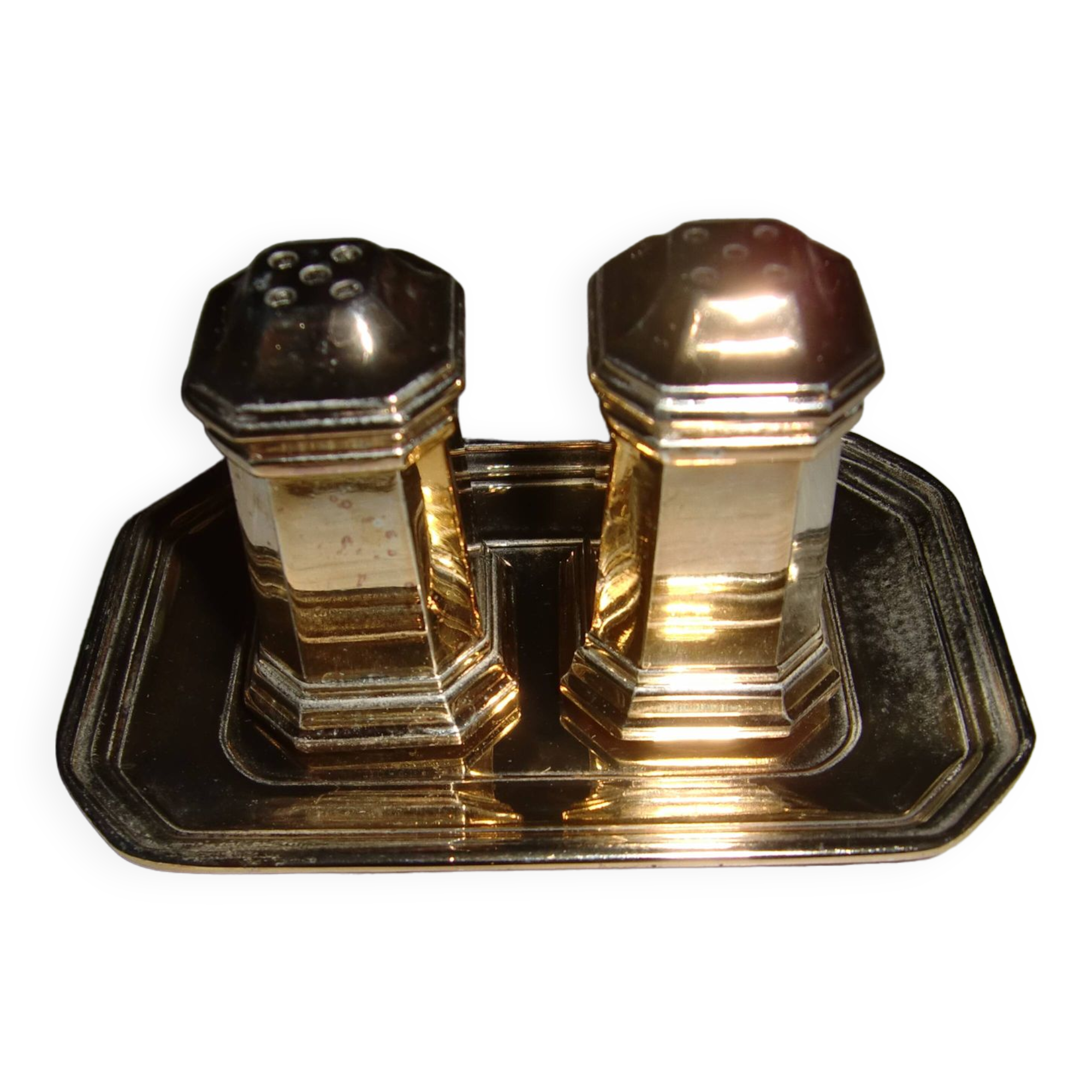 Silver-plated salt and pepper shakers presented on a small tray