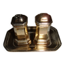 Silver-plated salt and pepper shakers presented on a small tray