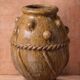 Glazed terracotta urn with protrusions and cordons.