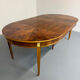 Round walnut Napoleon III extendable table with bronze top in good condition.