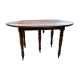 Table ronde en noyer de 130 cm de diamètre .