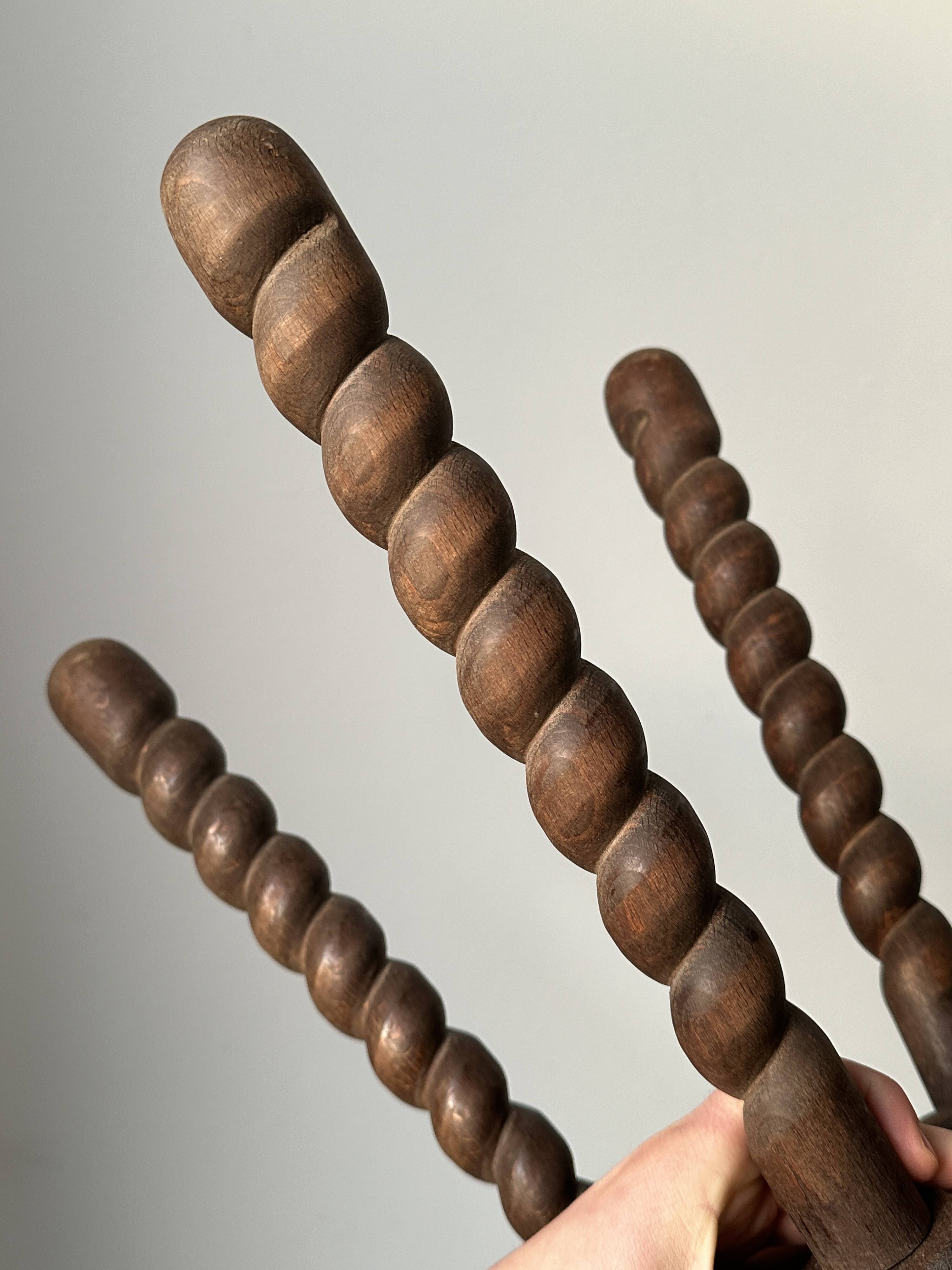 Wooden stool with three twisted legs