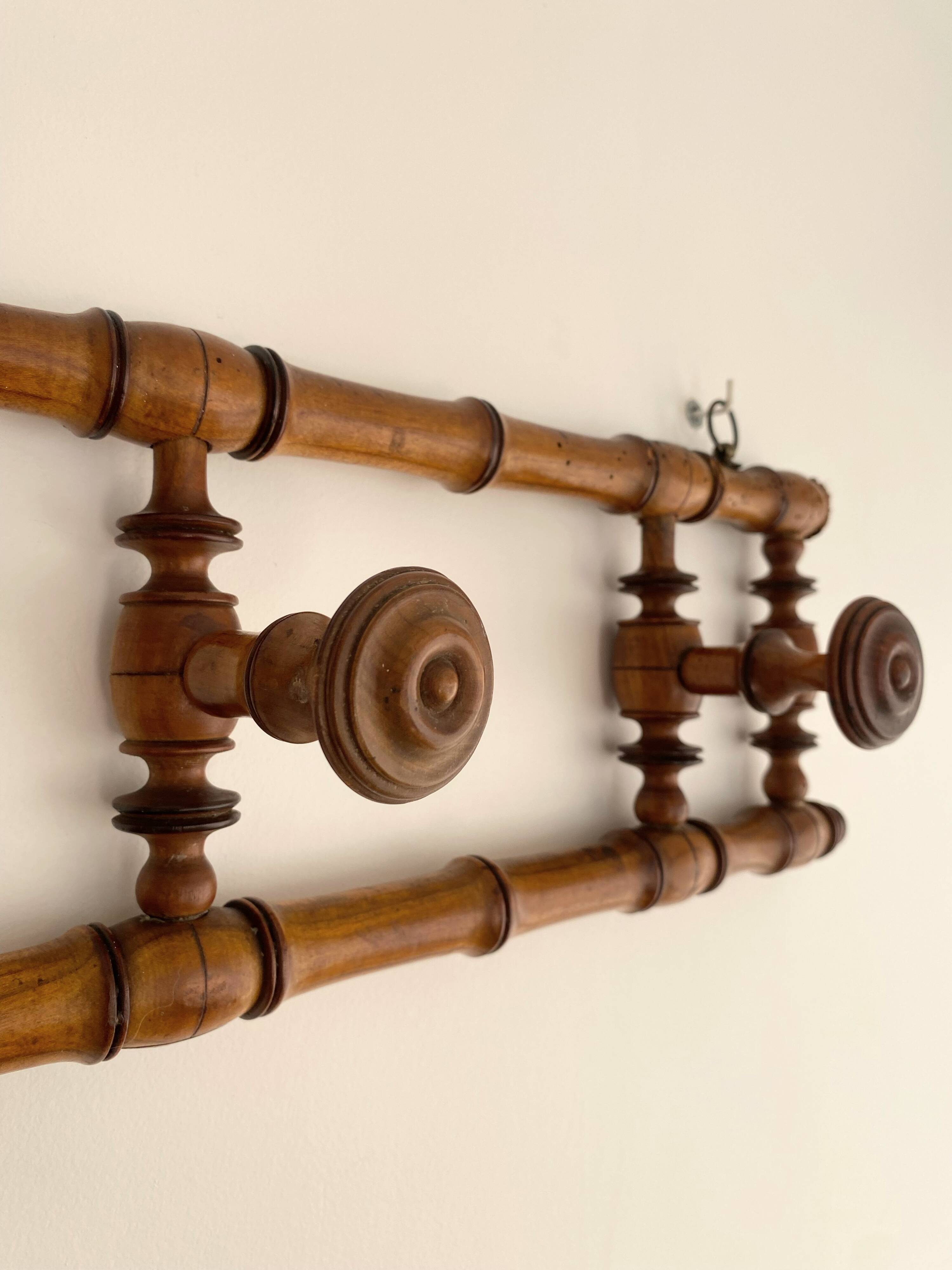 Vintage wooden wall coat rack with 4 swivel hooks from 1920
