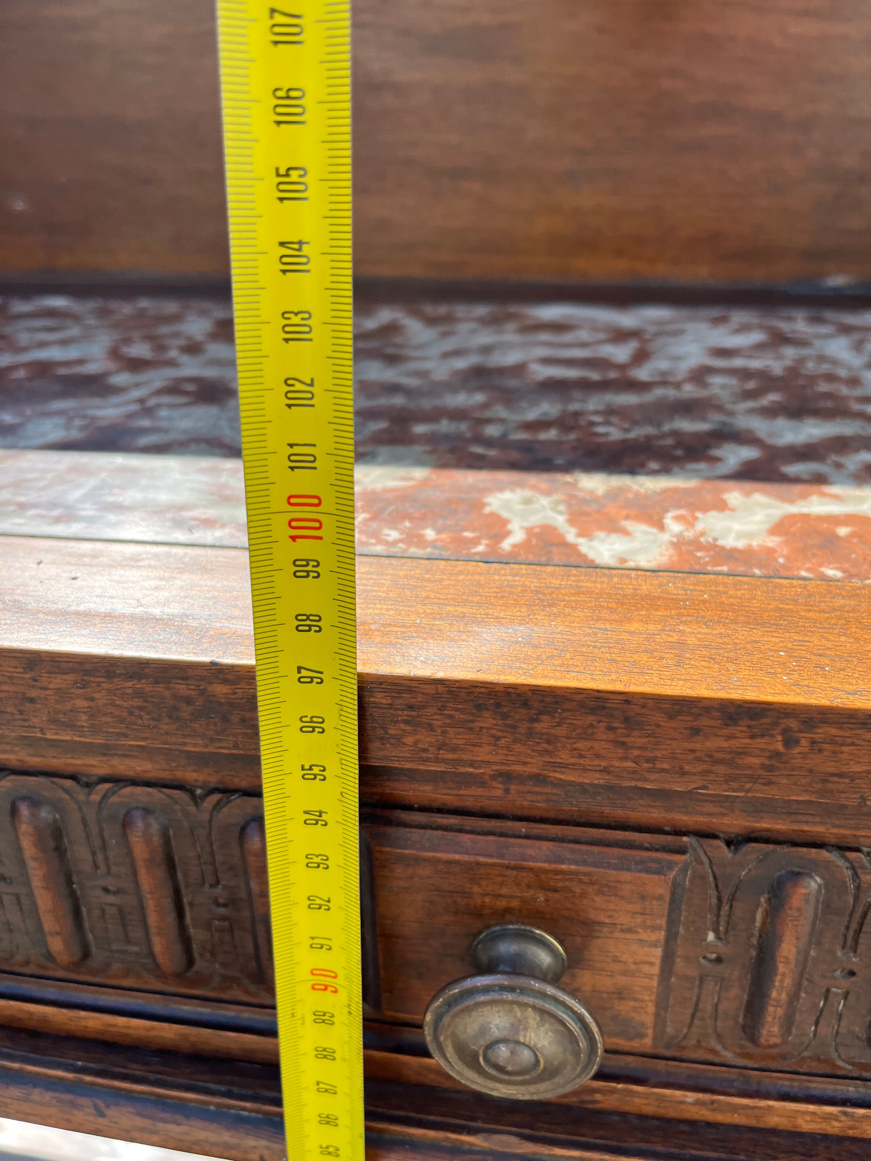 Carved wooden console table with three shelves and drop-leaf flap