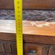 Carved wooden console table with three shelves and drop-leaf flap