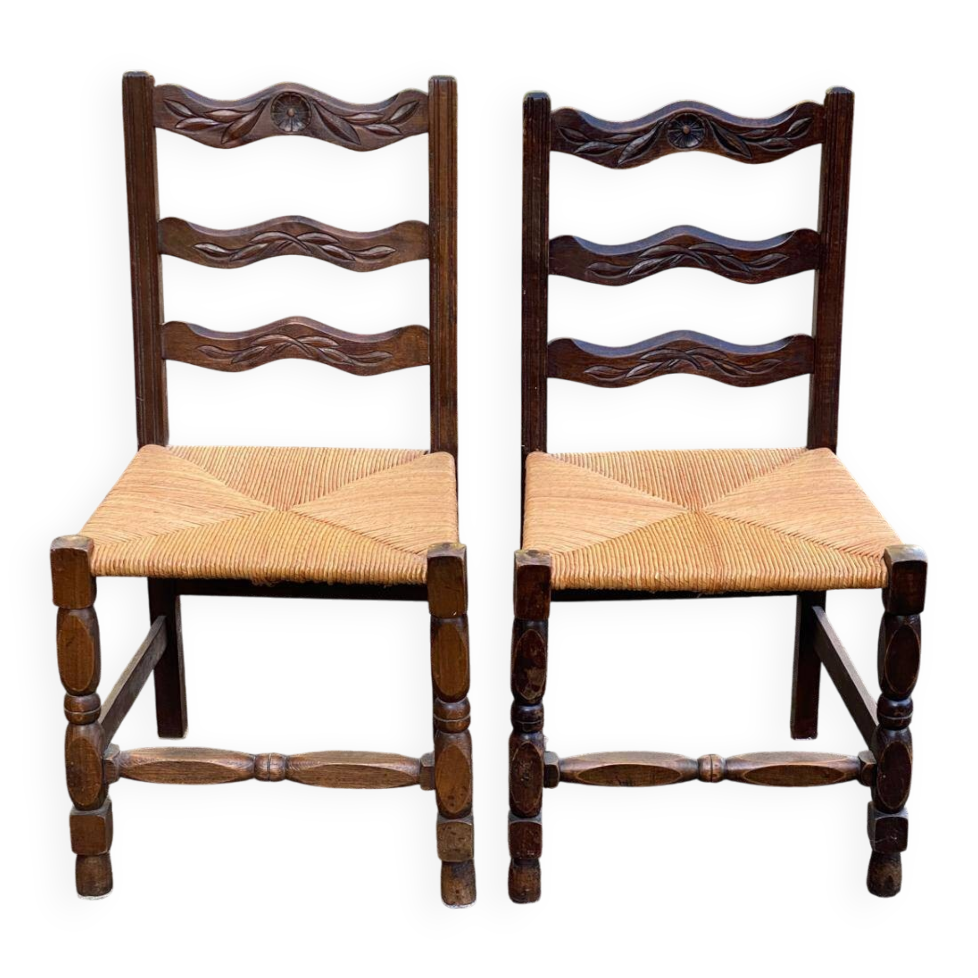 2 solid wood chairs with carved rush seats