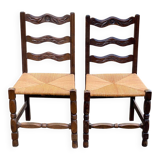 2 solid wood chairs with carved rush seats