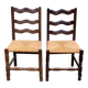 2 solid wood chairs with carved rush seats