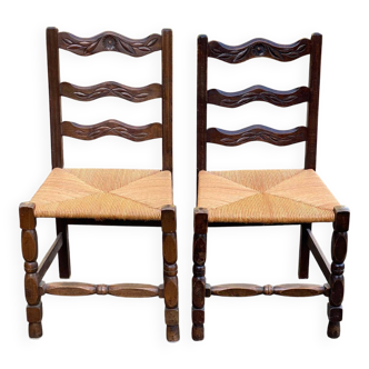 2 solid wood chairs with carved rush seats