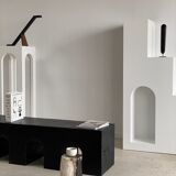 Black solid monoxyl wood bench carved into 3 arches