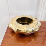Golden brass ashtray with bamboo decoration.