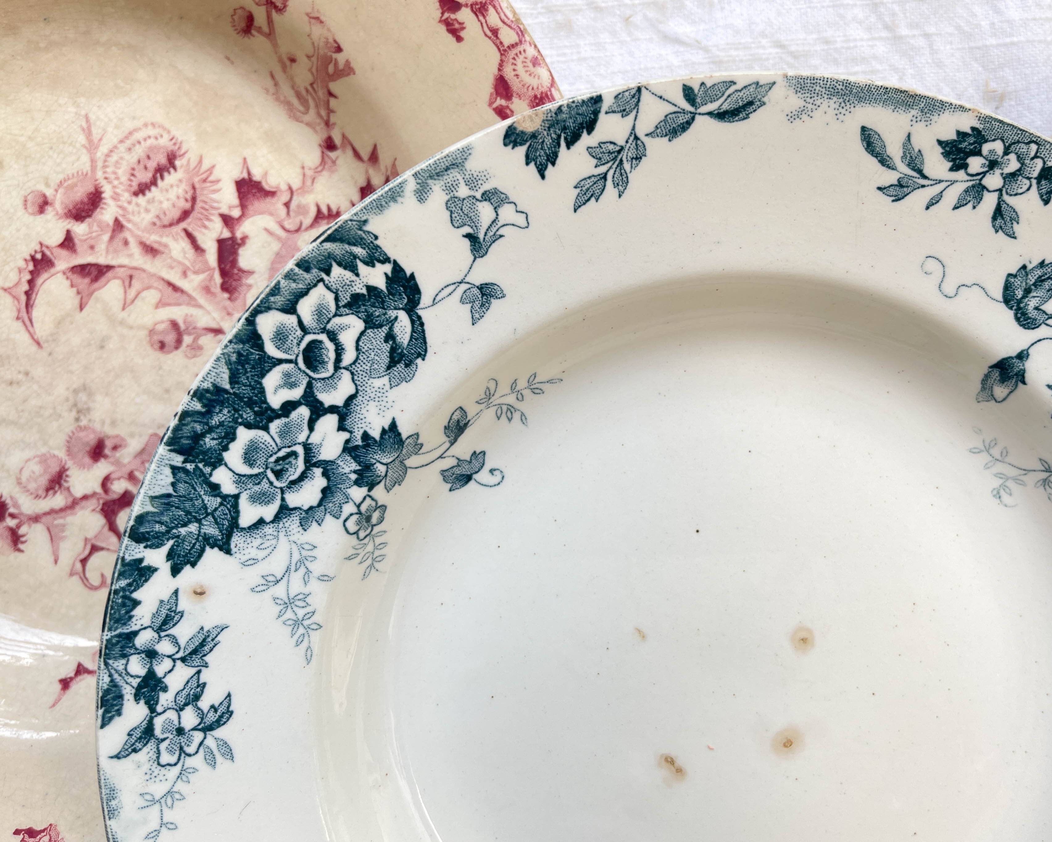 10 mismatched vintage soup plates in blue, green, and red ironstone