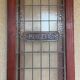 Late 19th century store doors, haberdashery front with Art Nouveau stained glass windows