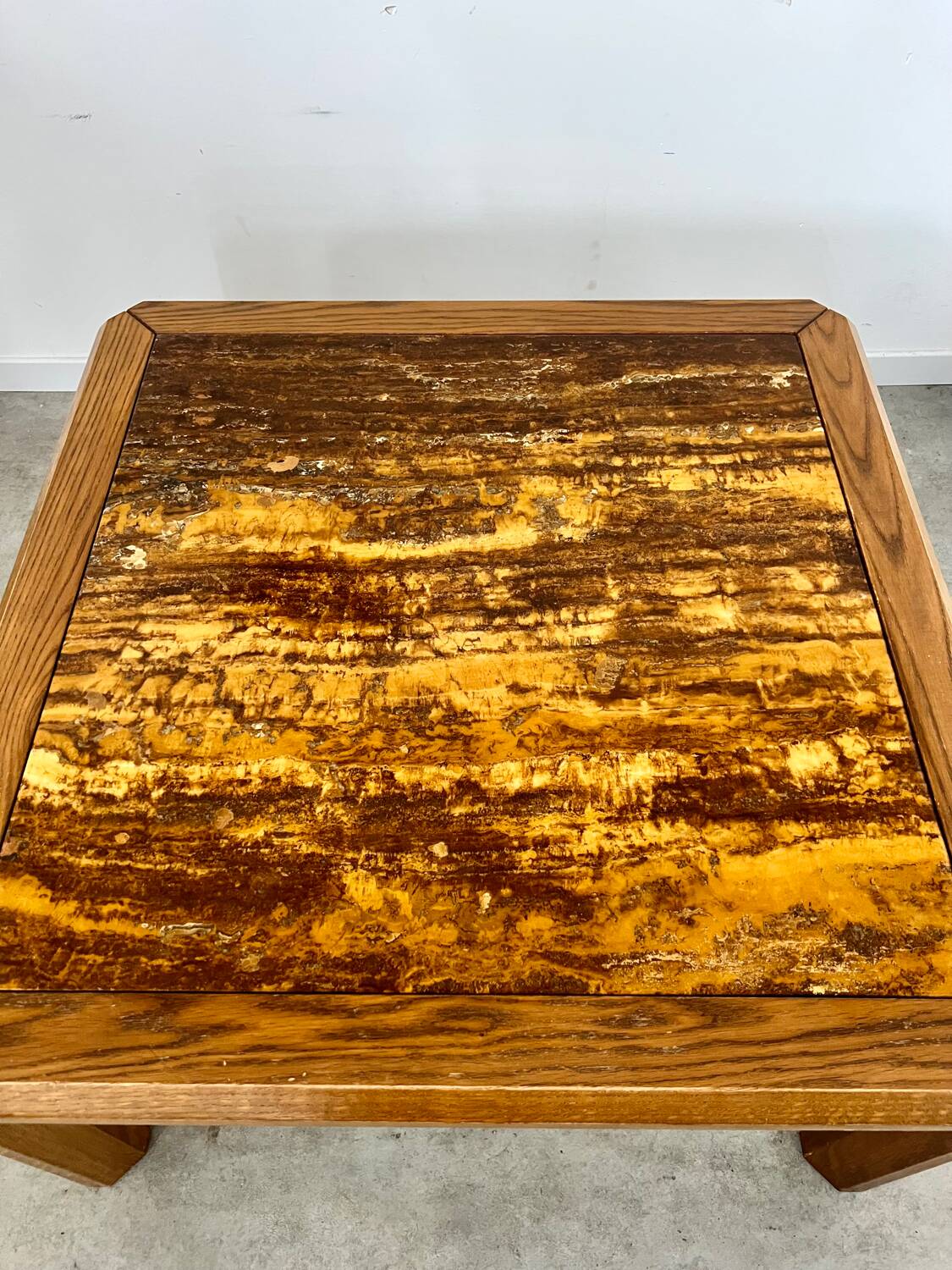 Old coffee table with golden marble top, 70s design, vintage wooden feet