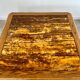 Old coffee table with golden marble top, 70s design, vintage wooden feet