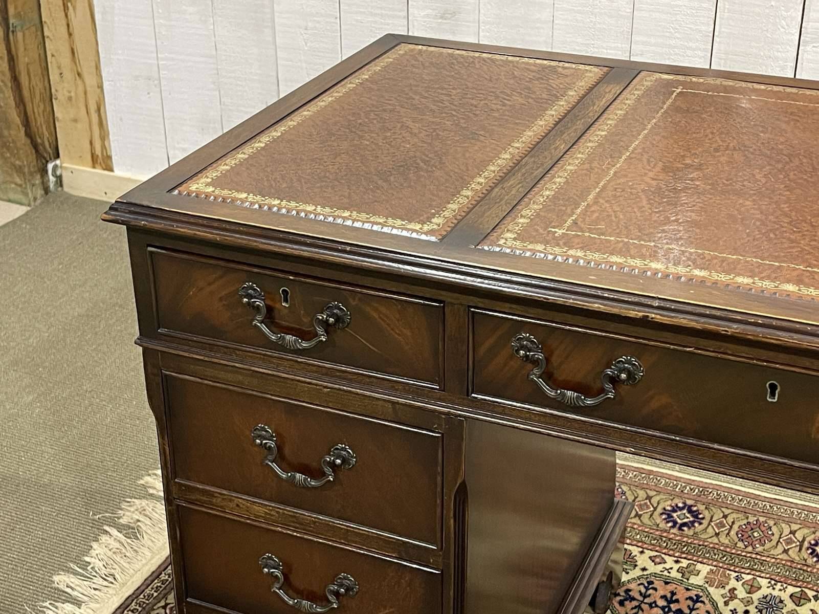 English mahogany pedestal desk with leather top from the 1950s