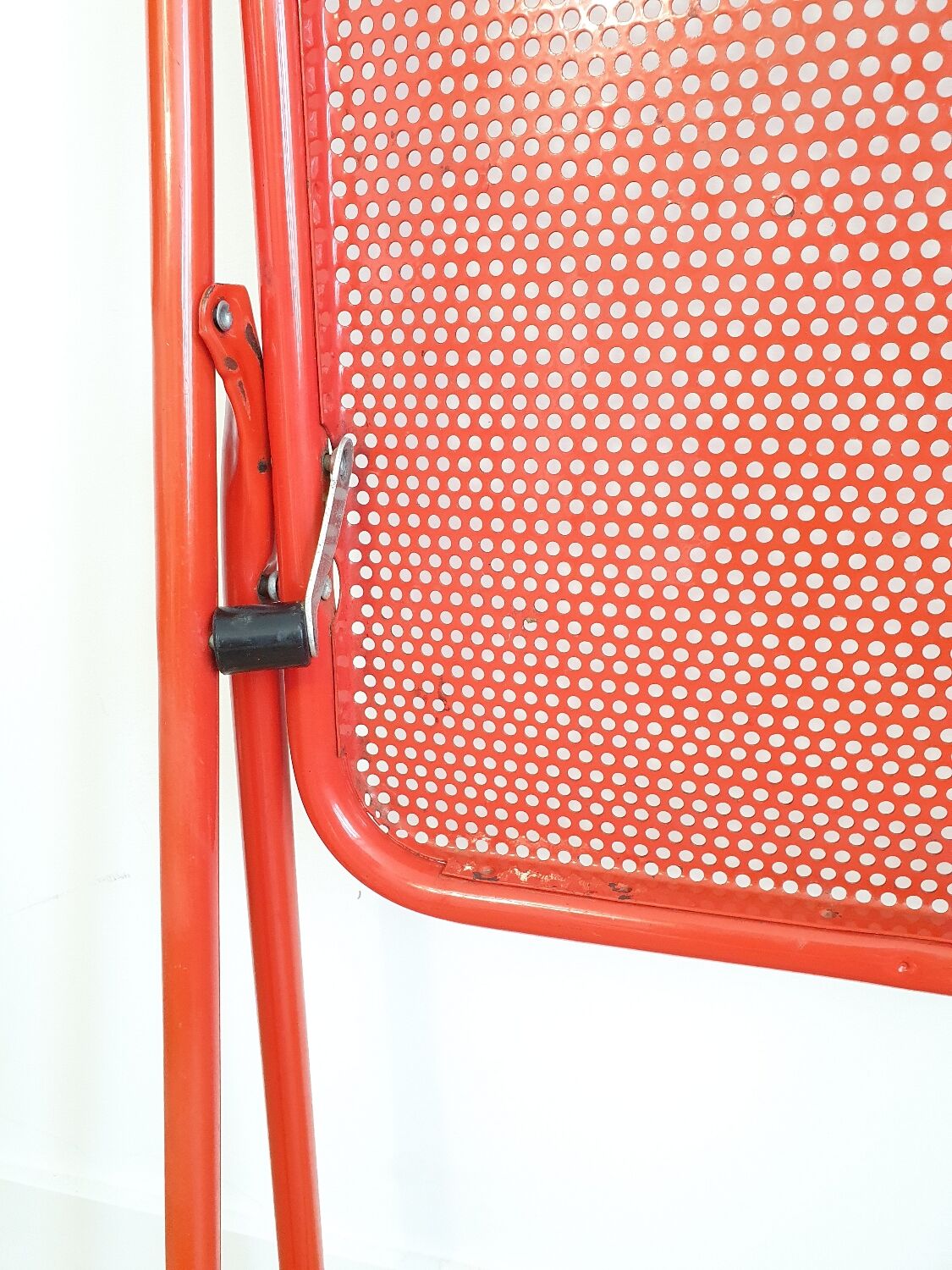 Perforated metal folding chair