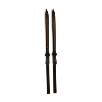 Pair of wooden skis with kandahar binding with its poles early twentieth century