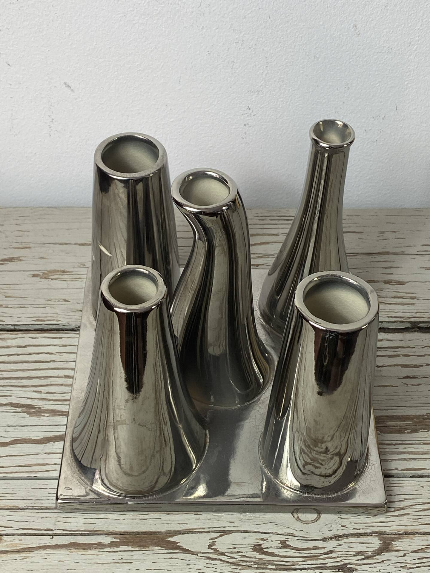 Asymmetrical multitube vase on a base, in silvered ceramic, 1970.