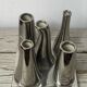 Asymmetrical multitube vase on a base, in silvered ceramic, 1970.