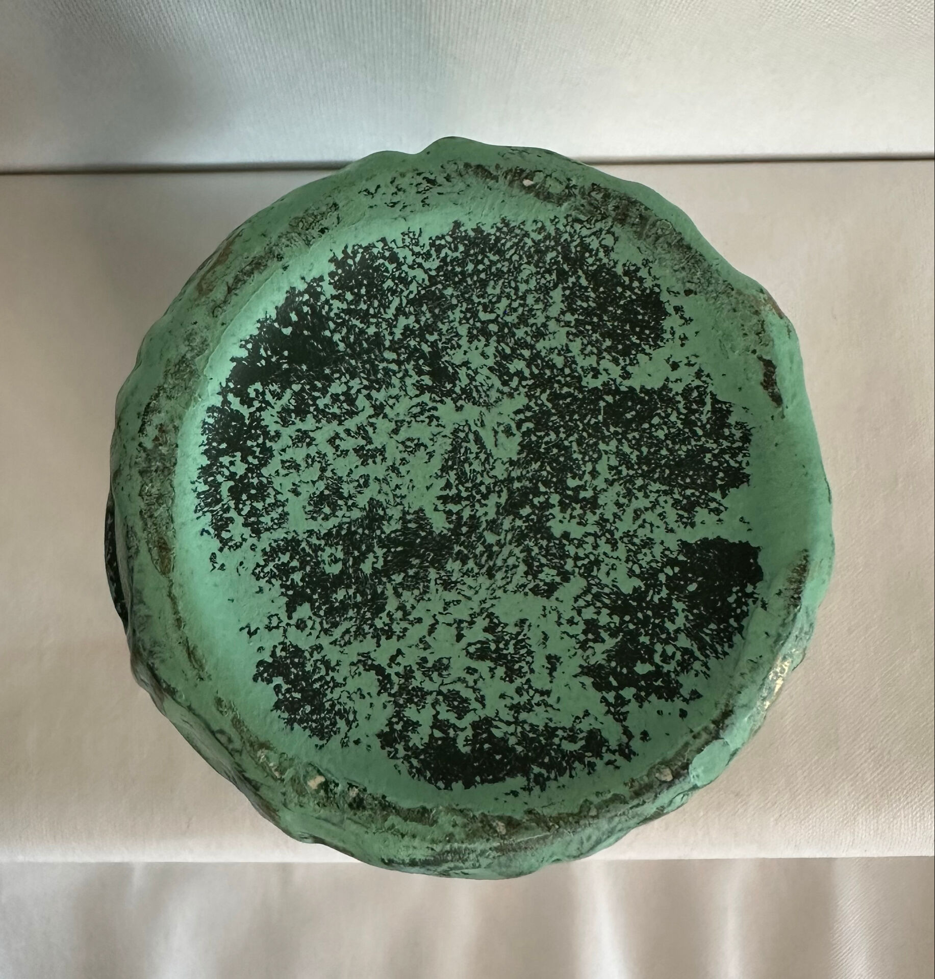 Vintage green patinated ceramic vase with raised floral decoration.